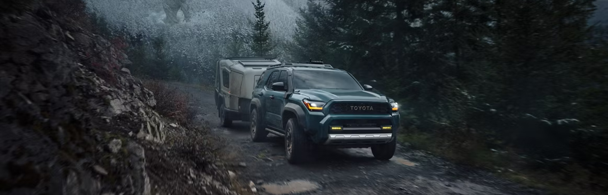 The New 2026 Toyota 4Runner at CMA's Toyota of Martinsburg in Martinsburg, WV | Green 2026 Toyota 4Runner driving on the some wet dirt while towing a trailer
