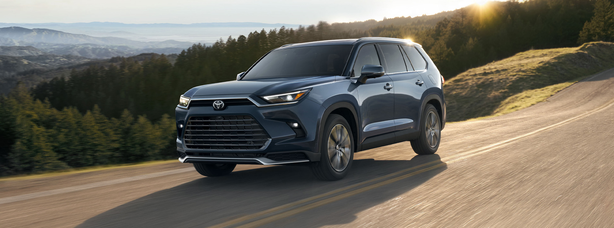The New 2026 Toyota Highlander and Grand Highlanders at CMA's Toyota of Martinsburg | 2026 Toyota Grand Highlander driving down the road The New 2026 Toyota Highlander and Grand Highlanders at CMA's Toyota of Martinsburg | 2026 Toyota Grand Highlander driving down the road
