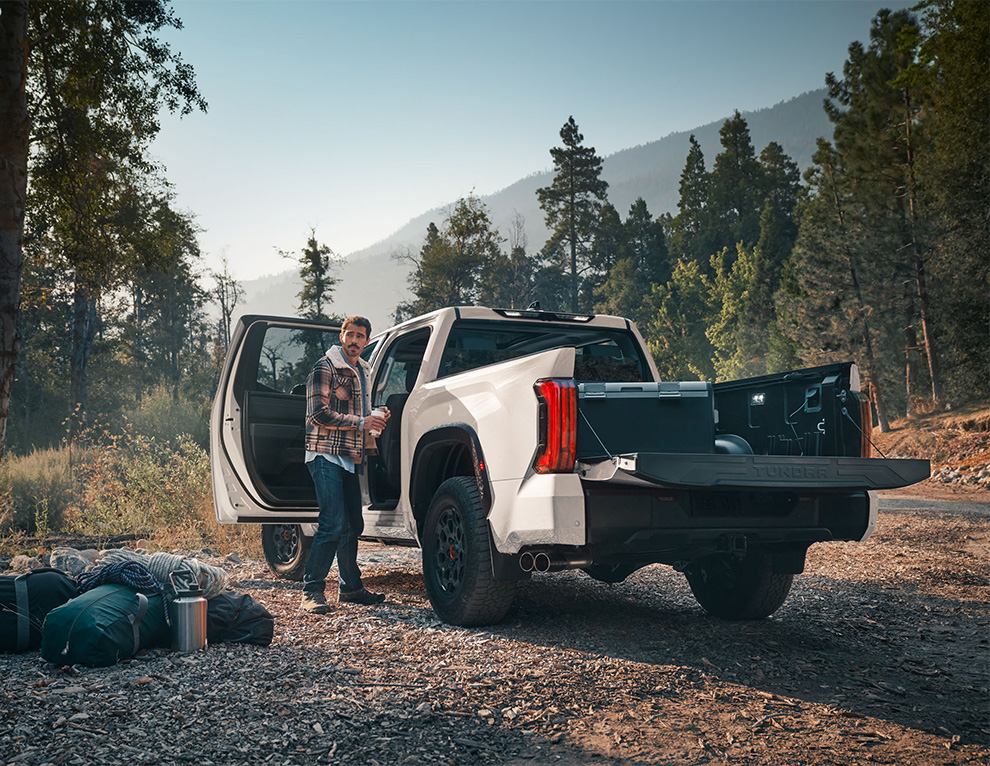 The New 2026 Toyota Tundra at CMA's Toyota of Martinsburg in Martinsburg, WV | Man camping in the woods with the trunk of his Toyota Tundra open