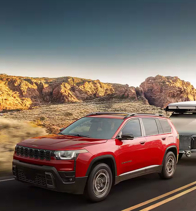 2026 Jeep Cherokee at CMA's CDJR of Martinsburg | Red 2026 Jeep Cherokee towing on the road