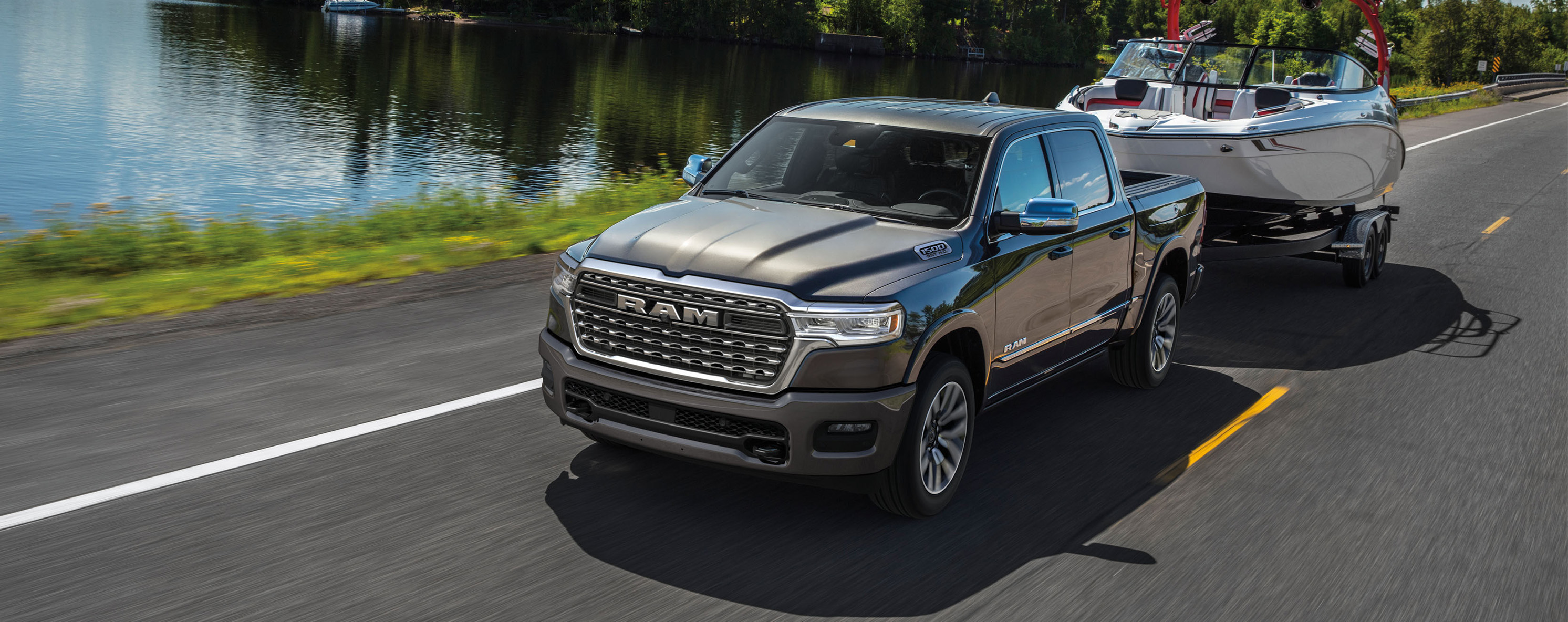 2026 Ram 1500 at CMA's CDJR of Martinsburg | 2026 Ram 1500 towing a boat on the road 2026 Ram 1500 at CMA's CDJR of Martinsburg | 2026 Ram 1500 towing a boat on the road