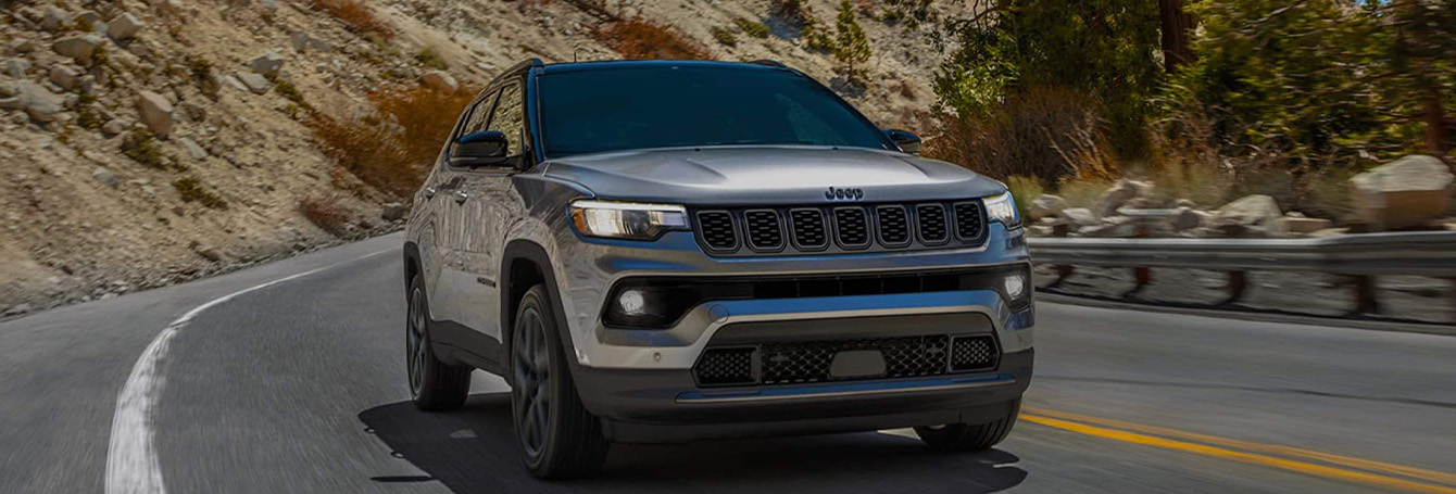 2026 Jeep Compass at Delaney CDJR of DuBois | 2026 Jeep Compass driving down a road 2026 Jeep Compass at Delaney CDJR of DuBois | 2026 Jeep Compass driving down a road