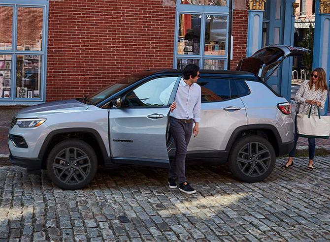 2026 Jeep Compass at Delaney CDJR of DuBois | Man getting out of his parked silver 2026 Jeep Compass 2026 Jeep Compass at Delaney CDJR of DuBois | Man getting out of his parked silver 2026 Jeep Compass