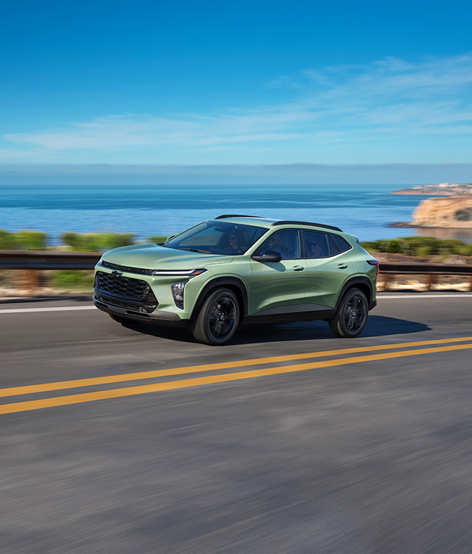 2026 Chevrolet Trax at Delaney Chevrolet of Greensburg | Front profile of a 2026 Chevrolet Trax in the color green, driving up a hill with a view of the ocean 2026 Chevrolet Trax at Delaney Chevrolet of Greensburg | Front profile of a 2026 Chevrolet Trax in the color green, driving up a hill with a view of the ocean