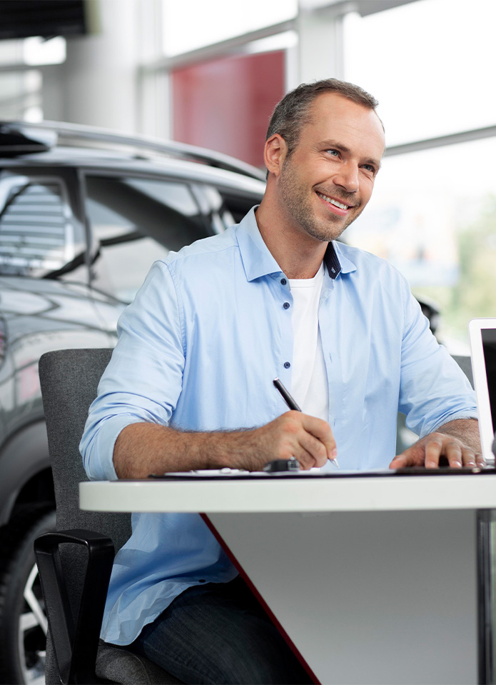Federal Auto Loan Interest Tax Deduction At Delaney Chevrolet of Indiana in Indiana, PA | customer smiling while about to sign the paper work for his new car Federal Auto Loan Interest Tax Deduction At Delaney Chevrolet of Indiana in Indiana, PA | customer smiling while about to sign the paper work for his new car
