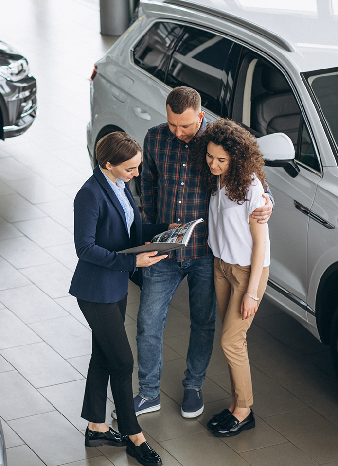 Federal Auto Loan Interest Tax Deduction in DuBois, PA | Sales associate showing a couple a book about their available auto loans Federal Auto Loan Interest Tax Deduction in DuBois, PA | Sales associate showing a couple a book about their available auto loans