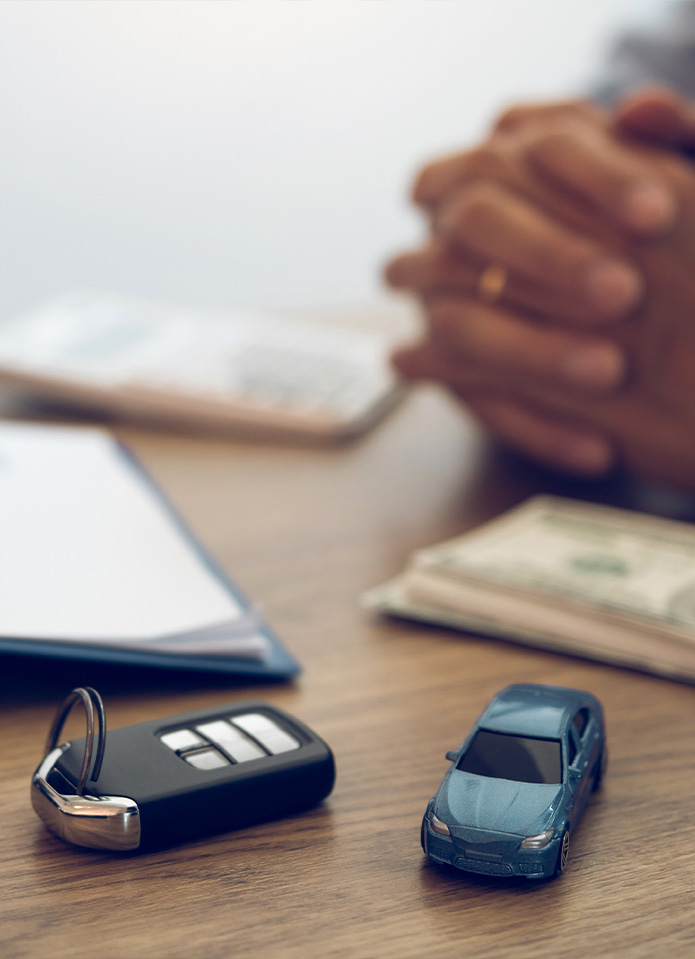 Federal Auto Loan Interest Tax Deduction At Delaney Hyundai of Indiana in Indiana, PA | Close up of car keys on the table next to a small model toy car in blue