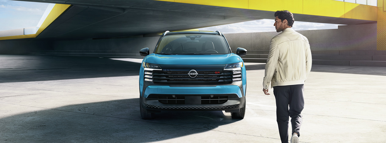 2026 Nissan Kicks at Delaney Nissan of Greensburg | Man walking up to his parked 2026 Nissan Kicks in the color blue 2026 Nissan Kicks at Delaney Nissan of Greensburg | Man walking up to his parked 2026 Nissan Kicks in the color blue