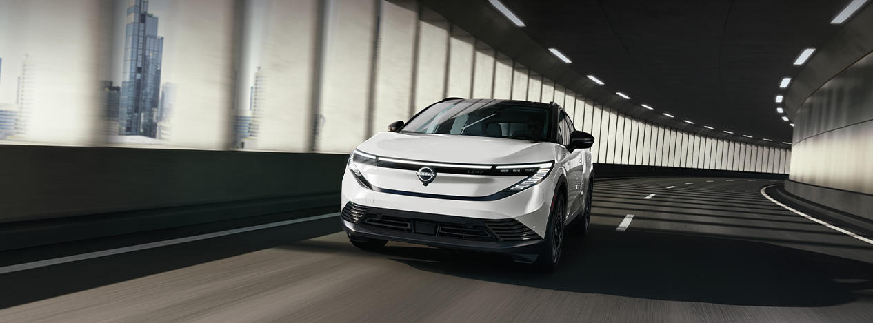 2026 Nissan Leaf at Delaney Nissan of Greensburg | White 2026 Nissan Leaf driving in a tunnel 2026 Nissan Leaf at Delaney Nissan of Greensburg | White 2026 Nissan Leaf driving in a tunnel