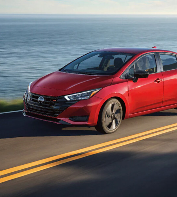 2026 Nissan Versa at Delaney Nissan of Greensburg | Red 2026 Nissan Versa driving down the road 2026 Nissan Versa at Delaney Nissan of Greensburg | Red 2026 Nissan Versa driving down the road