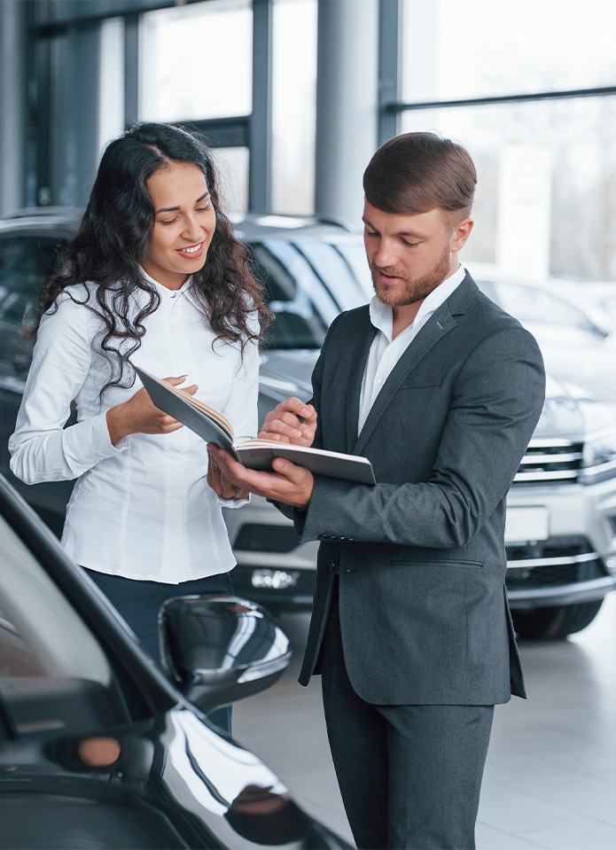 Federal Auto Loan Interest Tax Deduction At Delaney Nissan of Greensburg in Greensburg, PA | Sales associate in suit is talking to a customer about federal auto loan Federal Auto Loan Interest Tax Deduction At Delaney Nissan of Greensburg in Greensburg, PA | Sales associate in suit is talking to a customer about federal auto loan