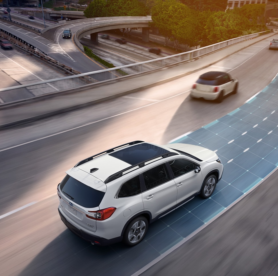 2026 Subaru Ascent at Delaney Subaru in Indiana, PA | Rear profile of a white Subaru Ascent driving down the highway 2026 Subaru Ascent at Delaney Subaru in Indiana, PA | Rear profile of a white Subaru Ascent driving down the highway