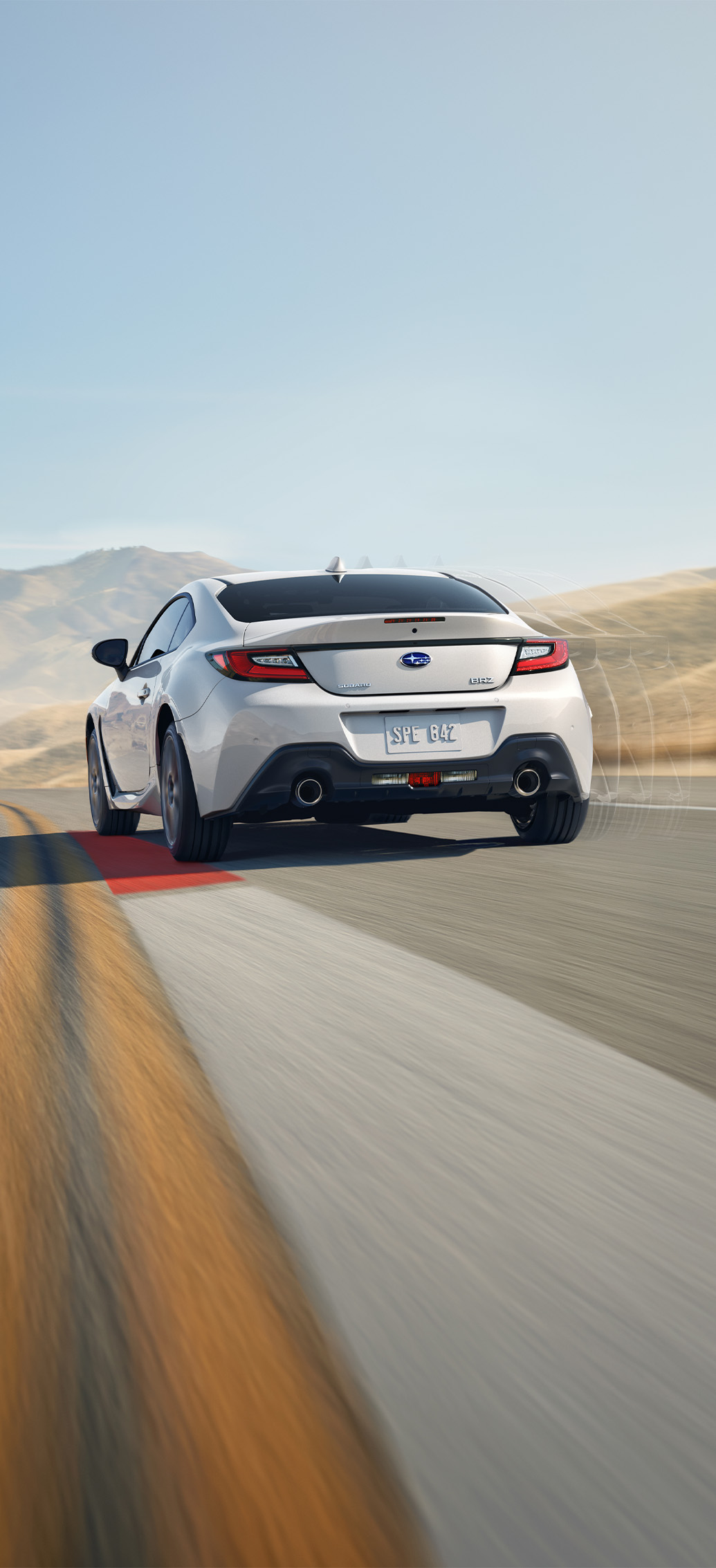 2026 Subaru BRZ at Delaney Subaru in Indiana, PA | Rear profile of a white 2026 Subaru BRZ driving down the road at high speeds 2026 Subaru BRZ at Delaney Subaru in Indiana, PA | Rear profile of a white 2026 Subaru BRZ driving down the road at high speeds