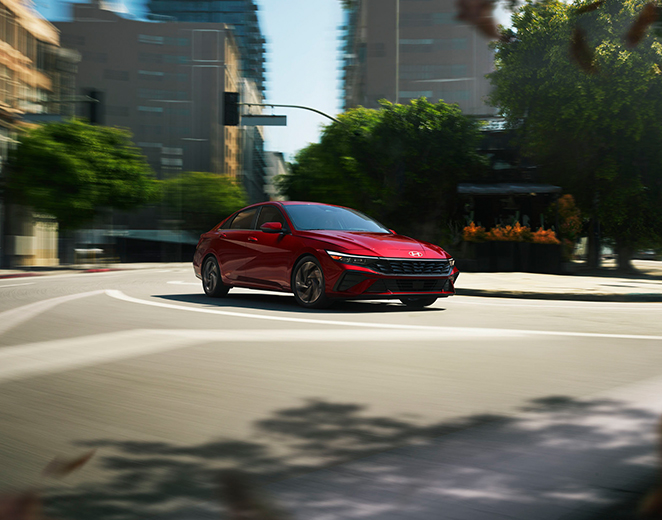 2026 Hyundai Elantra at Jack Giambalvo Hyundai | Red 2026 Hyundai Elantra driving down the street