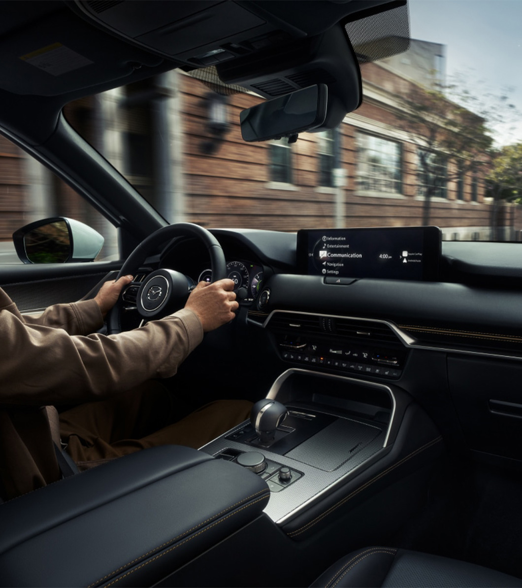 2026 Mazda CX-90 at Lancaster Mazda in East Petersburg, PA | Person with hands on the steering wheel driving down the road 2026 Mazda CX-90 at Lancaster Mazda in East Petersburg, PA | Person with hands on the steering wheel driving down the road
