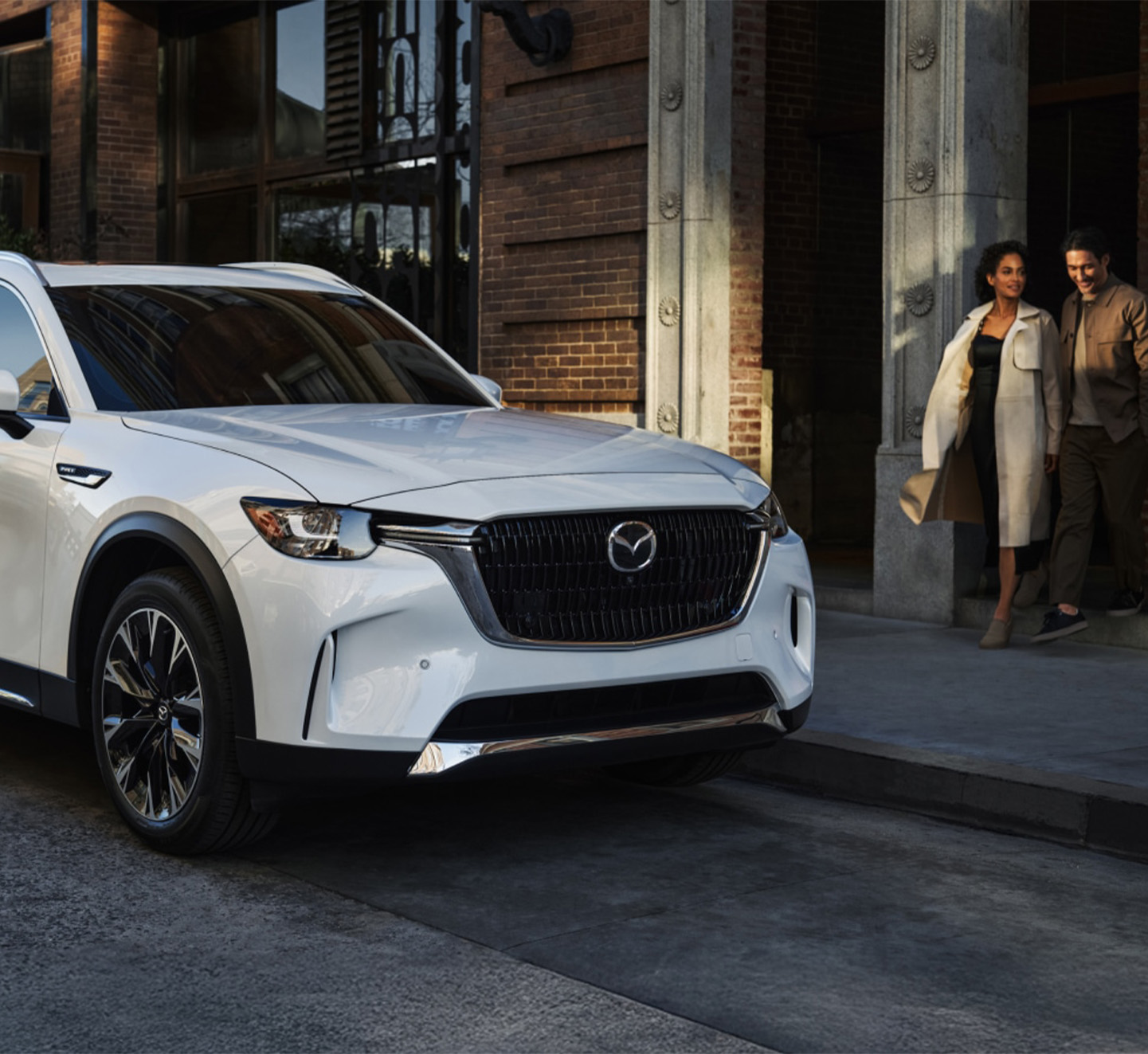 2026 Mazda CX-90 at Lancaster Mazda in East Petersburg, PA | Couple walking up to their parked 2026 Mazda CX-90 in the color white 2026 Mazda CX-90 at Lancaster Mazda in East Petersburg, PA | Couple walking up to their parked 2026 Mazda CX-90 in the color white
