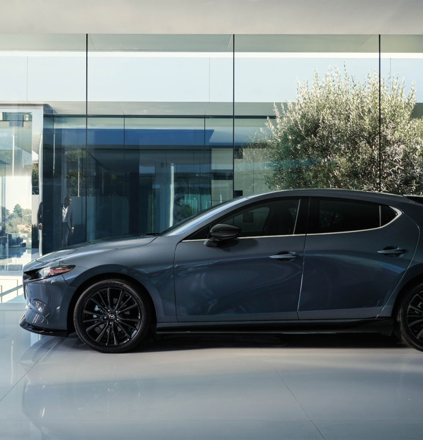 2026 Mazda3 Hatchback at Lancaster Mazda in East Petersburg, PA | Side profile of a 2026 Mazda 3 Hatchback in the color dark grey 2026 Mazda3 Hatchback at Lancaster Mazda in East Petersburg, PA | Side profile of a 2026 Mazda 3 Hatchback in the color dark grey