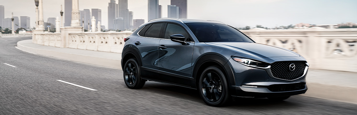2026 Mazda CX-30 at Lancaster Mazda | 2026 Mazda CX-30 driving down a city street 2026 Mazda CX-30 at Lancaster Mazda | 2026 Mazda CX-30 driving down a city street