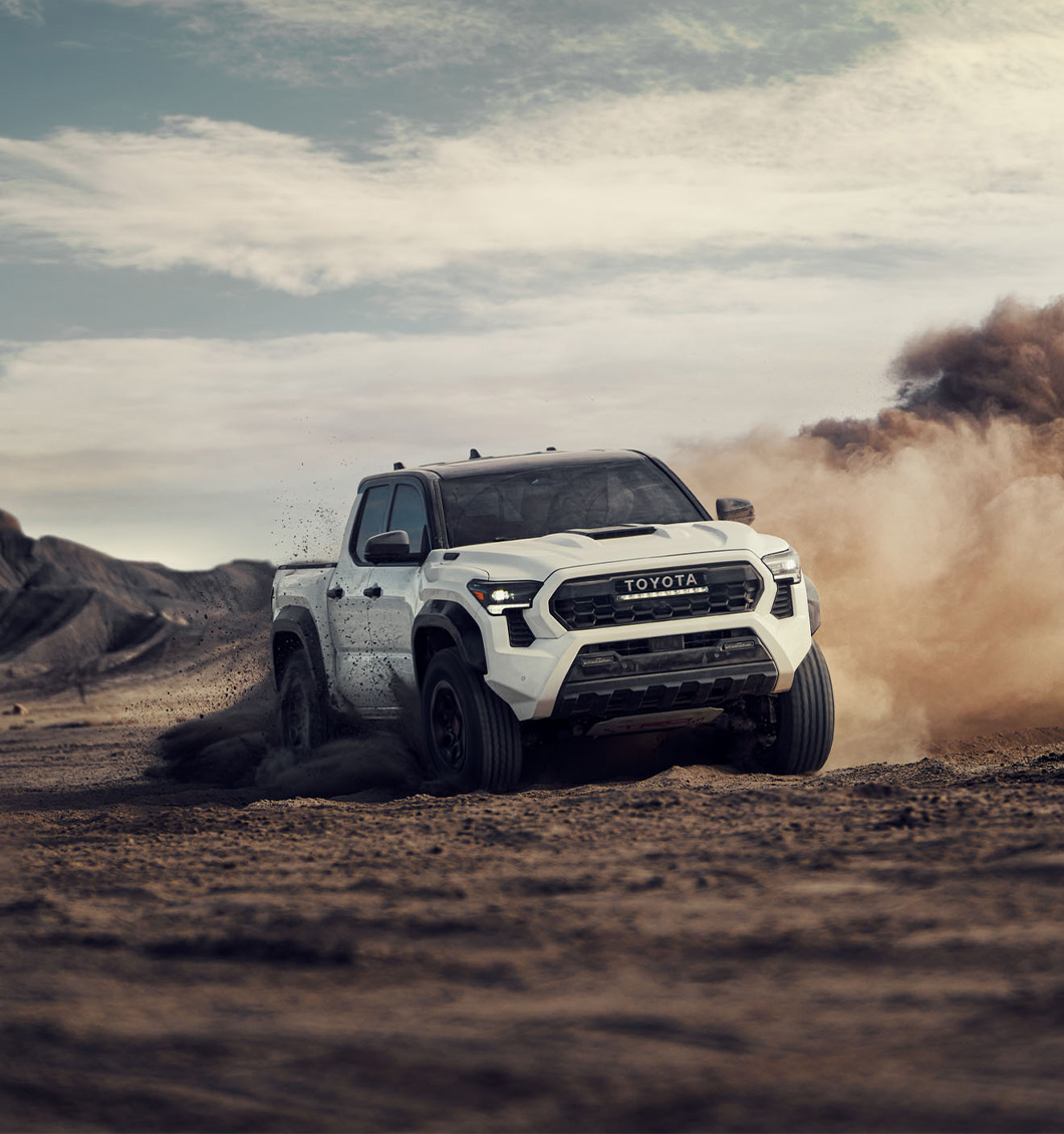 2026 Toyota Tacoma at Palmiero Toyota in Meadville, PA | White 2026 Toyota Tacoma driving in the dirt