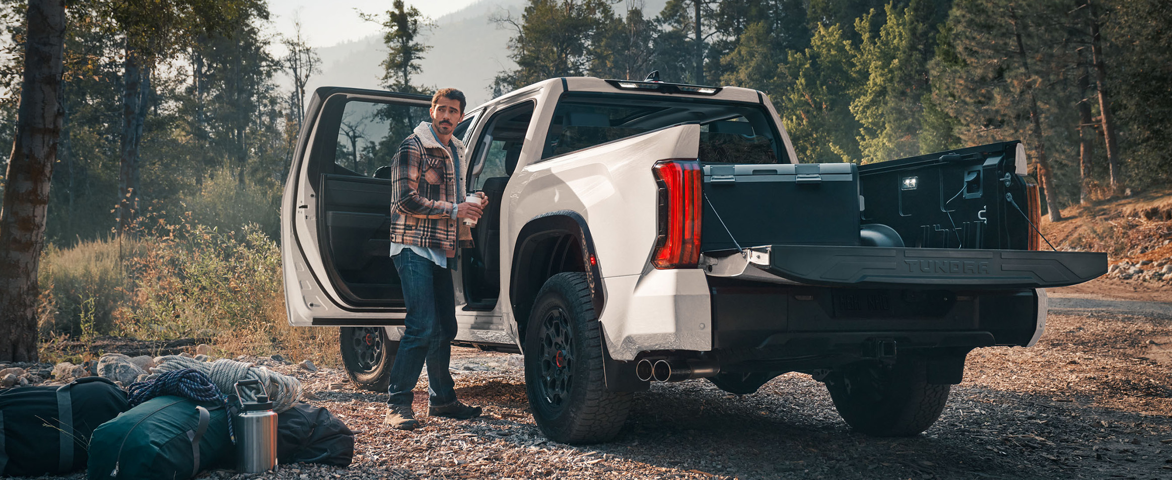 The New 2026 Toyota Tundra at Palmiero Toyota in Meadville, PA | Man standing beside his white 2026 Toyota Tundra with the trunk bed open The New 2026 Toyota Tundra at Palmiero Toyota in Meadville, PA | Man standing beside his white 2026 Toyota Tundra with the trunk bed open