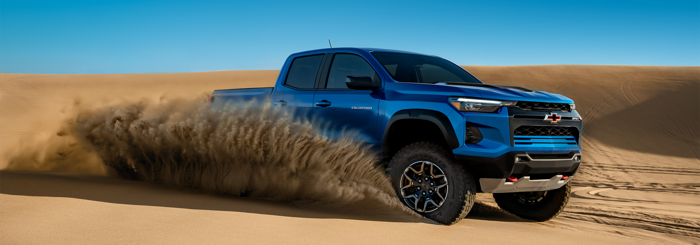 2026 Chevrolet Colorado at Sir Walter Chevrolet | Blue 2026 Chevrolet Colorado driving in the desert 2026 Chevrolet Colorado at Sir Walter Chevrolet | Blue 2026 Chevrolet Colorado driving in the desert