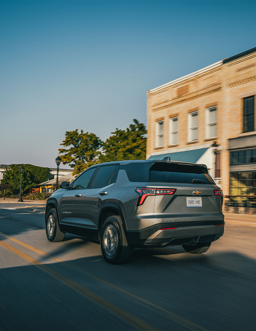 2026 Chevrolet Equinox at Sir Walter Chevrolet | Rear profile of a 2026 Chevrolet Equinox driving down the street 2026 Chevrolet Equinox at Sir Walter Chevrolet | Rear profile of a 2026 Chevrolet Equinox driving down the street