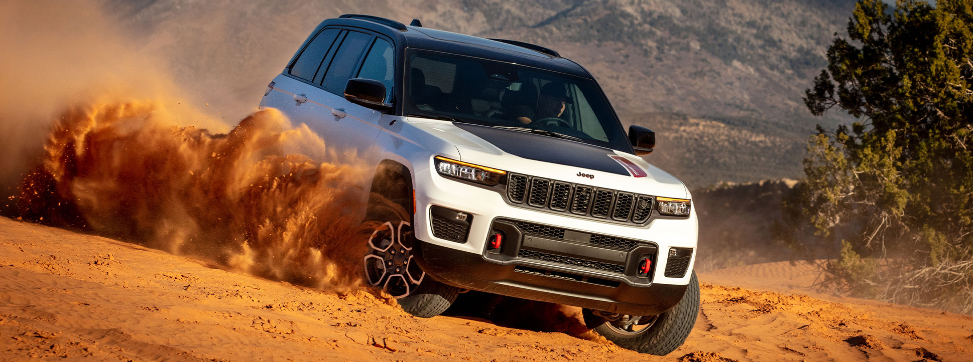 2026 Jeep Grand Cherokee at Stetler DCJR | White 2026 Jeep Grand Cherokee driving in the dirt