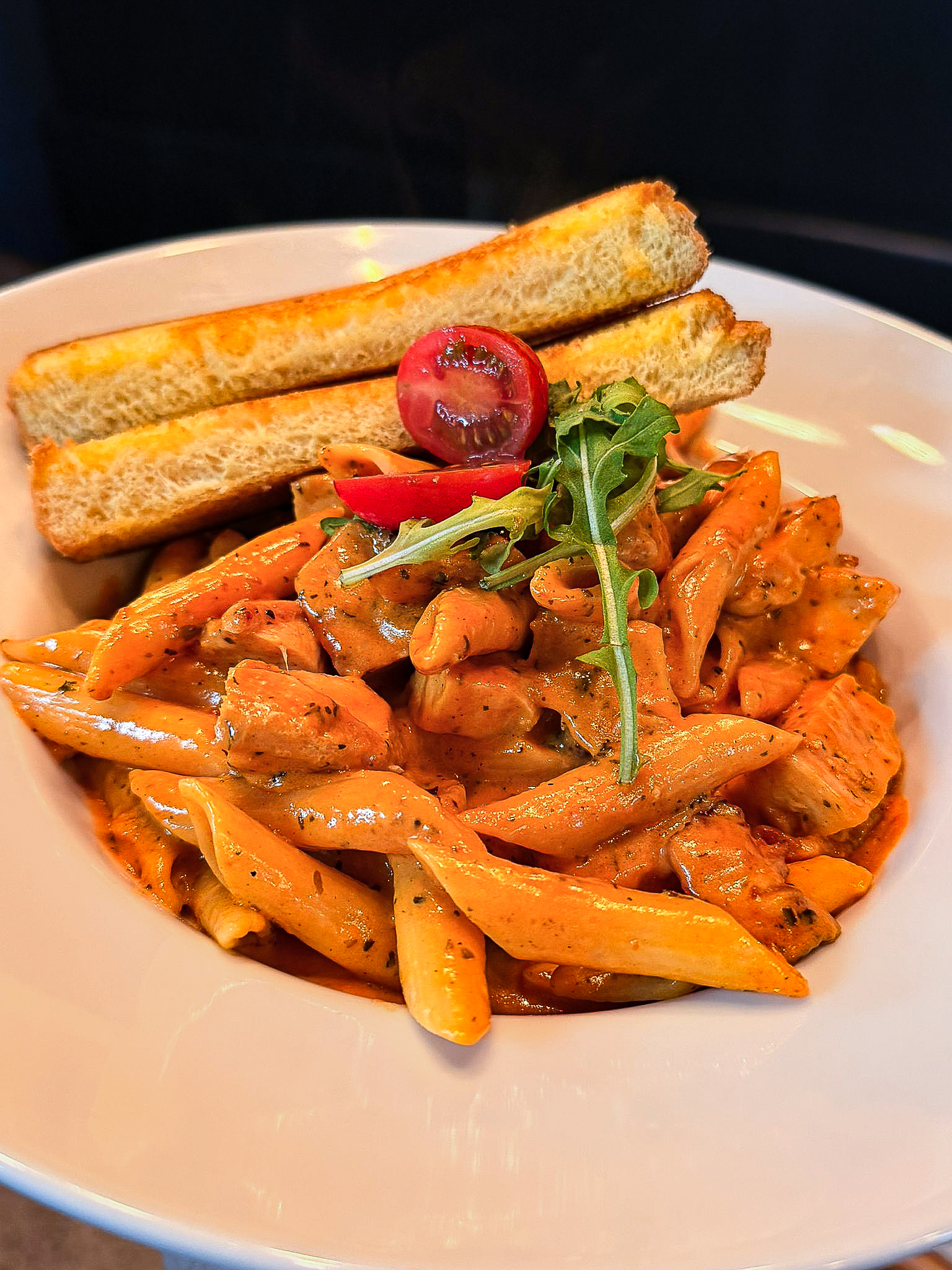 Pasta course finished with herbs and sauce