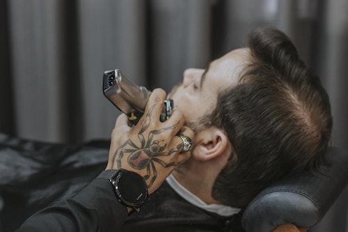 Barber-shaving-clients-beard-similar-to-usa-health-insurance-plan-shaving-down-barbers-deductibles