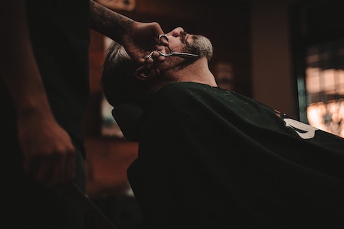 Barber-trimming-clients-beard-like-usa-health-insurance-plan-trims-barbers-health-insurance-premiums