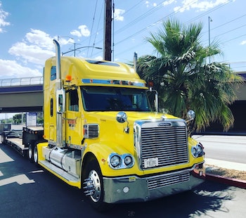 Trucker-driving-yellow-semi-truck-usa-health-insurance-plan