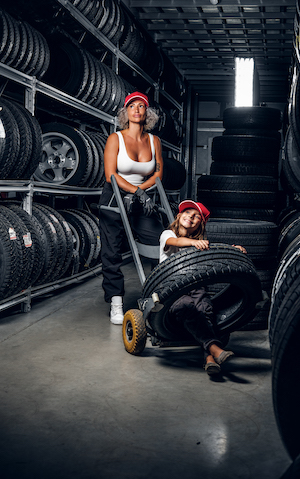 woman-trucker-delivery-tires-with-daughter-family-health-insurance-plan-woman-is-carrying-tyre-on-the-truck-with-girl-2021