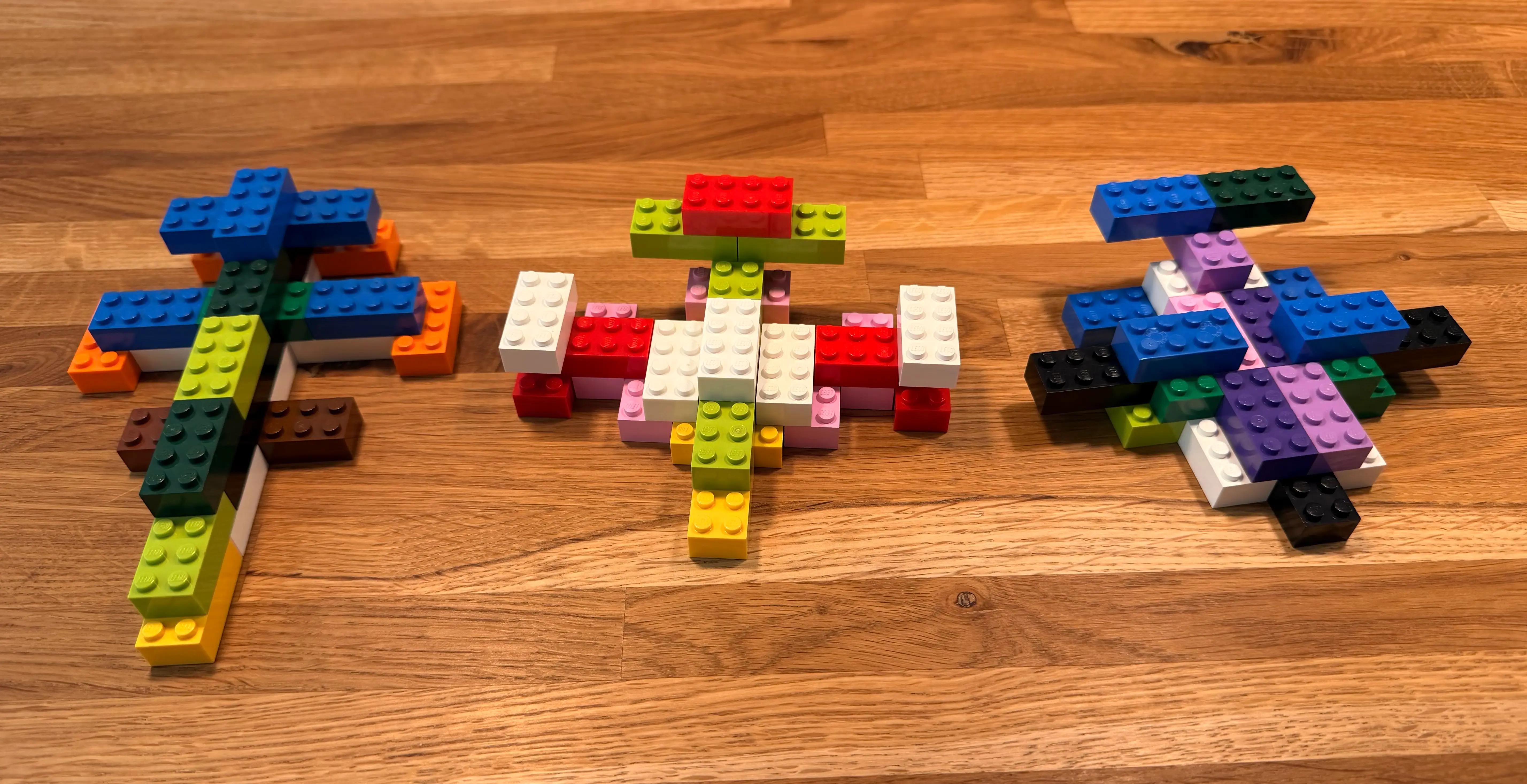 Prompt: Draw a starship using no more than twenty-five identical 2x4 classic Lego bricks in five colors.