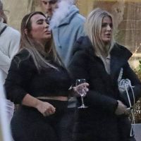 Lauren Goodger dons a black crop top as she enjoys dinner with pals