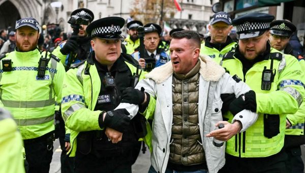 Tommy Robinson is led away by police during London anti-Semitism protest