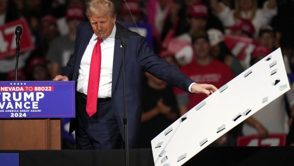 Trump, after mocking Harris over teleprompter use, stops rally to remove sign that fell on his