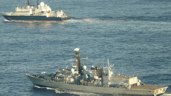 A British submarine secretly tracking a Russian spy ship hanging around undersea cables surfaced nearby to send a message, UK says