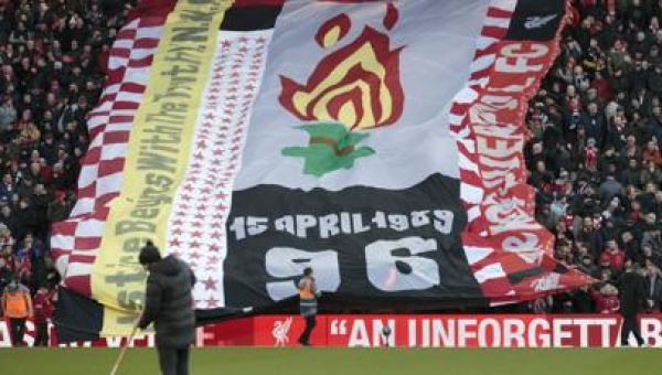 The UK apologizes to families of 97 Liverpool soccer fans killed in a stadium crush 34 years ago