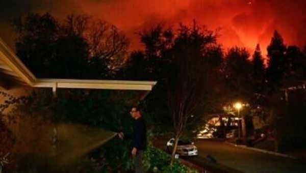 Firefighters race to beat LA blazes as winds grow and death toll hits 16