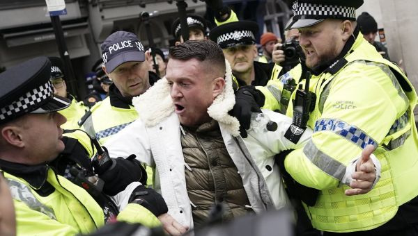 Tommy Robinson pepper sprayed during march against antisemitism