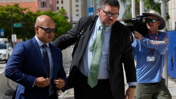 Feds, Trump aide’s lawyers clash over secret documents hearing date