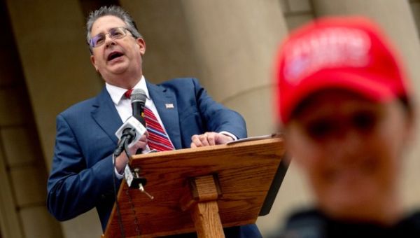 Trump allies in Michigan criminally charged with mishandling voting machines