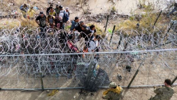 WATCH: Large Migrant Group Pushes Past Texas Military at El Paso Border
