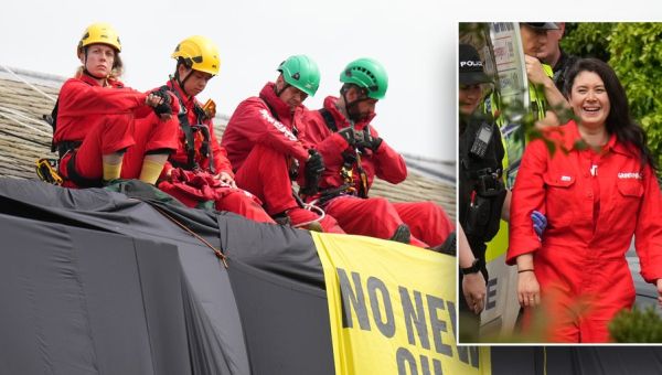Greenpeace climate protesters climb atop UK prime minister's home, hang black fabric
