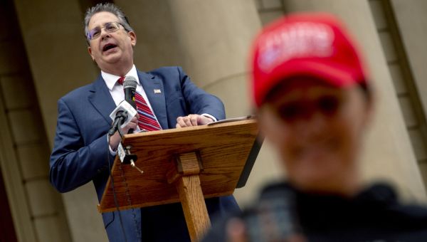 Trump’s Michigan allies charged with taking 2020 voting machines, tampering with them