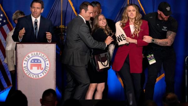 Two protesters storm stage during DeSantis speech in New Hampshire
