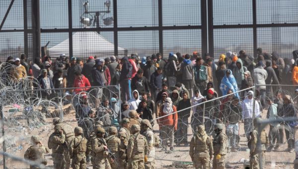 Over 100 migrants rush US border and knock guards out of the way