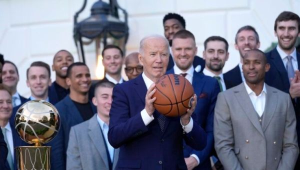Watch: President Biden pump-fakes a basketball and passes it to Al Horford