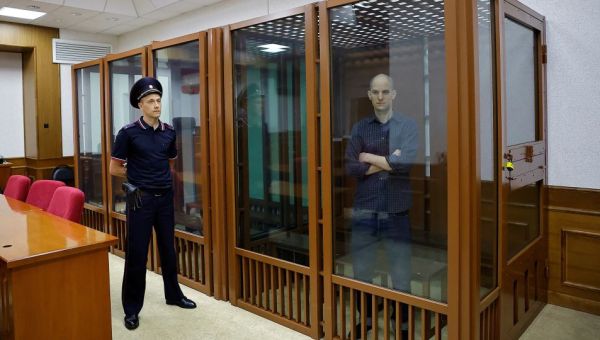 Evan Gershkovich appears in glass cage as espionage trial begins in Russia