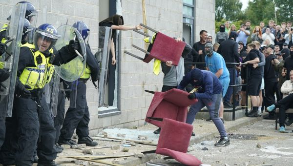 Yobs light fires & hurl missiles at migrant hotels as violence sweeps UK